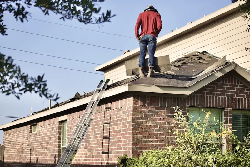 Professional roofer working on a residential roof in Grosse Pointe Shores